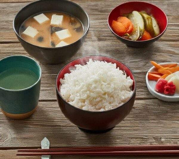 "Bowl of steamed Japanese White Rice, fluffy and slightly sticky, embodying the simplicity and elegance of traditional Japanese cuisine."